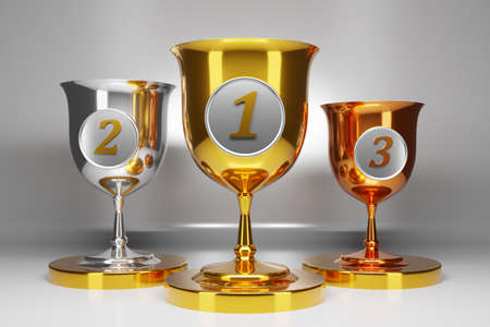 3d illustration of three gold, silver and bronze goblets on gray isolated background. Sports competition awards concept. Award symbolsの写真素材