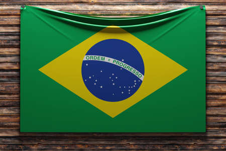 3D illustration of the national fabric flag of Brazil nailed on a wooden wall .Country symbol.の写真素材