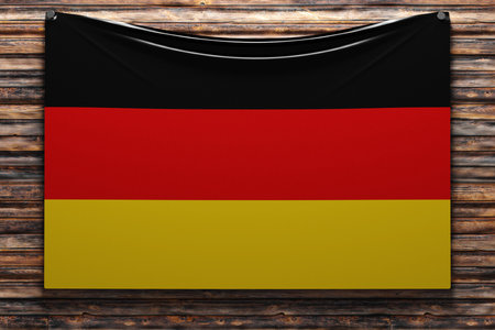 3D illustration of the national fabric flag of Germany nailed on a wooden wall .Country symbol.