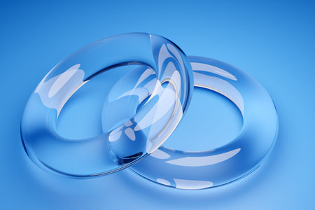 3D illustration of transparent wedding rings on a blue background. Geometric shapes in the form of a...