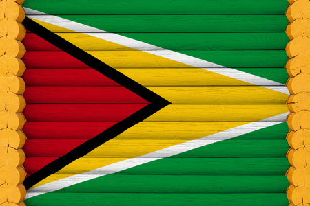 National flag of Guyana on a wooden wall background. The concept of national pride and a symbol of...