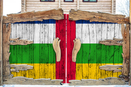 Close-up of the national flag of Central African Republic on a wooden gate at the entrance to the closed territory. The concept of storage of goods, entry to a closed area.の写真素材