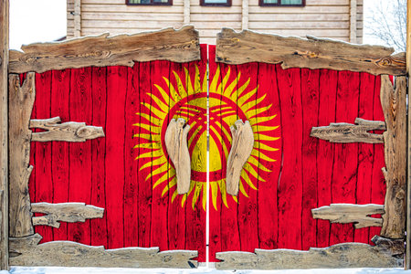 Close-up of the national flag of Kyrgyzstan on a wooden gate at the entrance to the closed territory. The concept of storage of goods, entry to a closed area.の写真素材