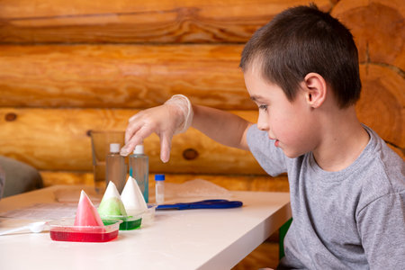 Chemistry education and training concept. Close-up of a boy dipping a cone into a solution in a...