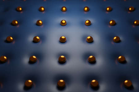 3d illustration of golden metal balls in even rows on a blue fabric. Pattern with the same beads.の写真素材