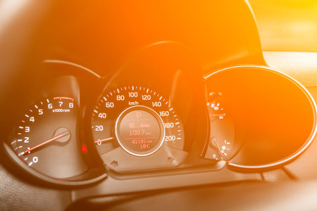 speedometer of a modern car with an integrated fuel gauge in the tank with white arrows under the...