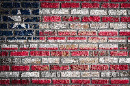 National flag of Liberia depicting in paint colors on an old brick wall. Flag banner on brick wall background.の写真素材