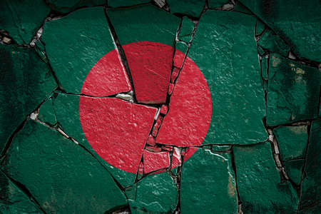 National flag of Bangladesh depicting in paint colors on an old stone wall. Flag banner on broken wall background.の写真素材