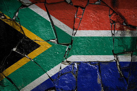 National flag of South African Republic depicting in paint colors on an old stone wall. Flag banner on broken wall background.の写真素材