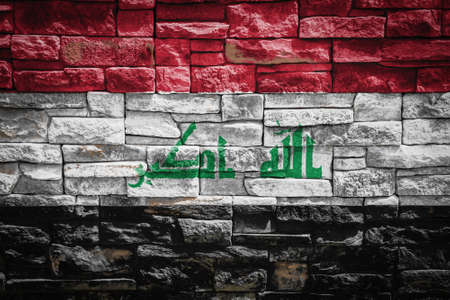 National flag of Irak on stone wall background The concept of national pride and symbol of the country. Flag banner on stone texture background.の写真素材