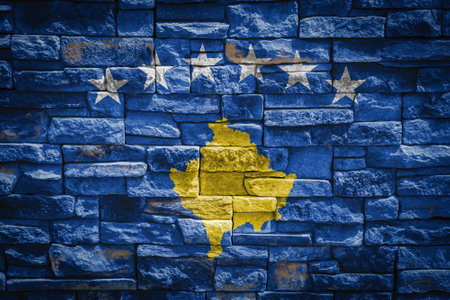 National flag of Kosovo on stone wall background. The concept of national pride and symbol of the country. Flag banner on stone texture background.の写真素材