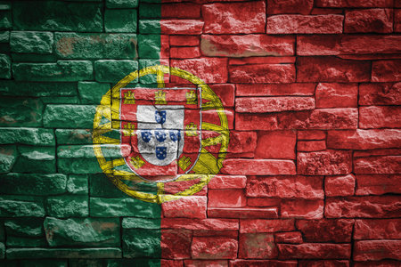 National flag of Portugal on stone wall background. The concept of national pride and symbol of the country. Flag banner on stone texture background.の写真素材