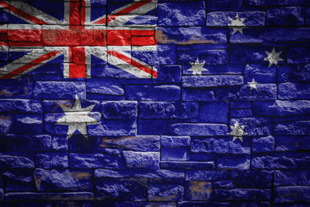 National flag of Australia on stone wall background The concept of national pride and symbol of the country. Flag banner on stone texture background.の写真素材