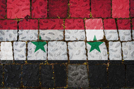 National flag of Syria on stone wall background. Flag banner on stone texture background.の写真素材