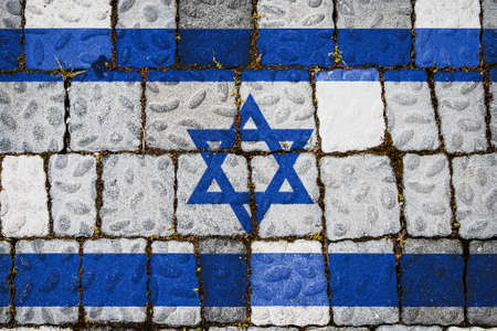 National flag of Israel on stone wall background. Flag banner on stone texture background.の写真素材