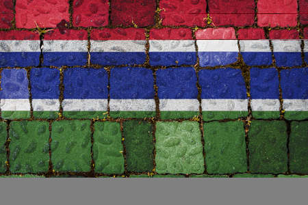 National flag of Gambia on stone wall background. Flag banner on stone texture background.の写真素材