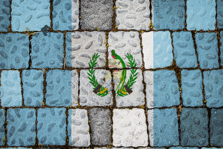 National flag of Guatemala on stone wall background. Flag banner on stone texture background.