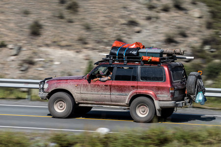 Novosibirsk, Russia - August 08, 2021: red Toyota Land Cruiser jeep driving fast on freeway in...