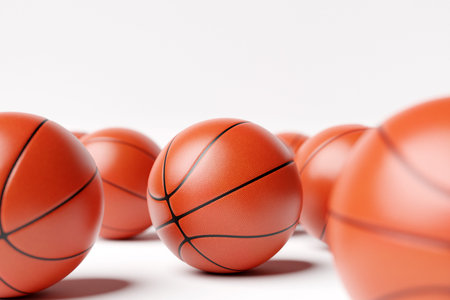 3d illustration of basketball balls. A lot of orange basketball balls lie on a white isolated background. Realistic render with sport swordsの写真素材