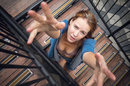 Creative portrait of a woman on an industrial theme. Modern portrait of a woman in shotrs and top posing against the background of an industrial container, top viewの写真素材