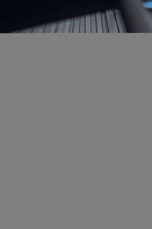 Creative portrait of a red-haired woman in a short shorts and top. Design concept. Romantic portrait of young woman posing in urban areaの写真素材