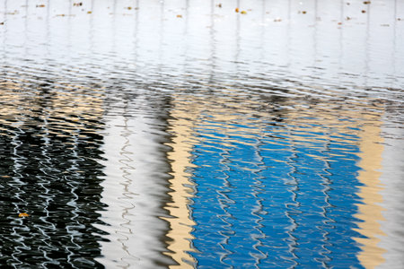 Blue water surface. The texture of water ripples on the surface of the puddle is dark