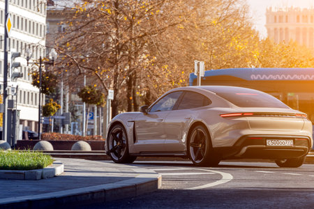 Moscow; Russia - October 13; 2021: gray Porsche Taycan turbo is driving fast on the street on a warm...