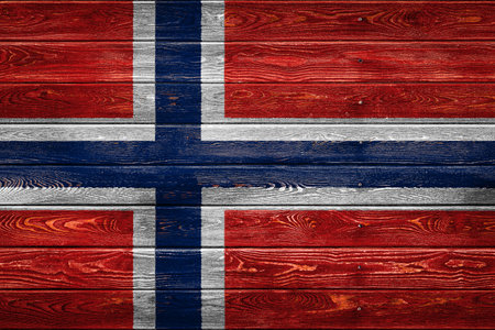 The national flag of Norway is painted on a camp of even boards nailed with a nail. The symbol of the country.の写真素材