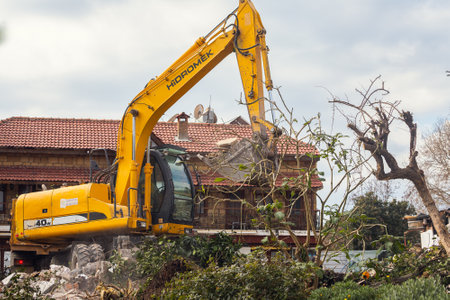 Side, Turkey -January 22, 2022: Excavator on demolition the old buildingon. Backhoe the destruction of concrete and hard rockのeditorial素材