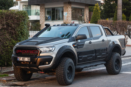 Side, Turkey -January 22, 2022: black pickup Ford Ranger is parked on the street on a warm day against the backdrop of a fence, gardenのeditorial素材