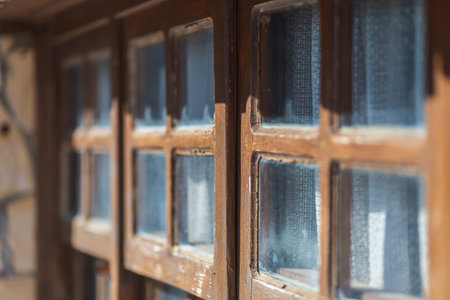 Close-up brown wooden vintage window in an old stone houseの写真素材