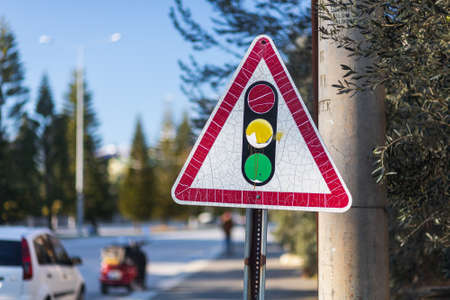 Old road sign traffic light on the background of a city streetの写真素材