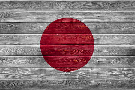 The national flag of Japan is painted on a camp of even boards nailed with a nail. The symbol of the country.の写真素材