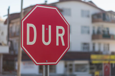 Close-up of a stop road sign on the background of a city streetの写真素材