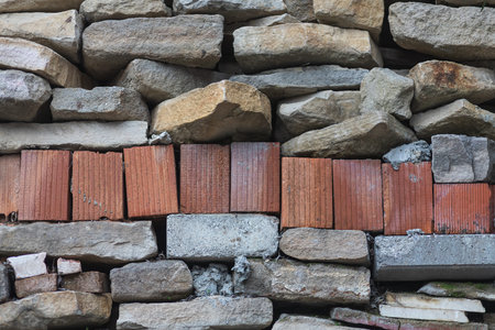 Background of brown-gray stone wall with brick. Pattern of slate wall texture and background