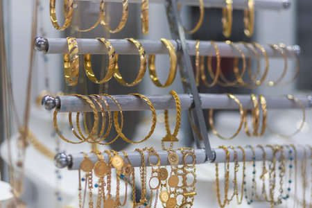Jewelry shop window with a huge selection of gold jewelry bracelets, chains, rings