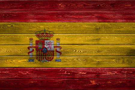 The national flag of Spain is painted on a camp of even boards nailed with a nail. The symbol of the country.の写真素材