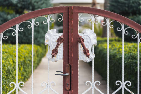 close-up of a beautiful forged gate in a city parkの写真素材
