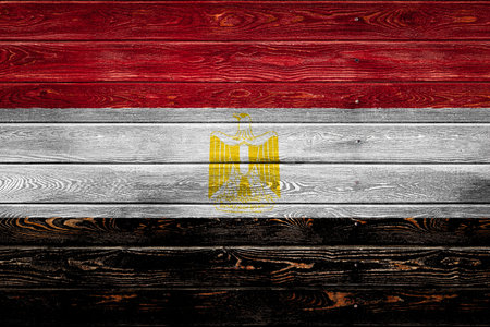 The national flag of Egypt is painted on a camp of even boards nailed with a nail. The symbol of the...