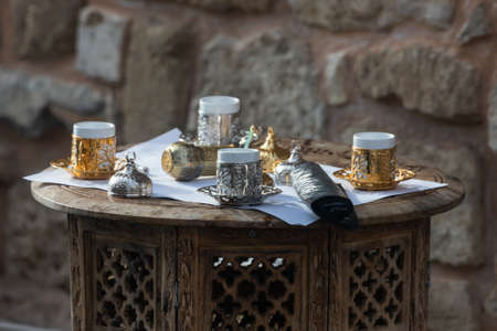 Close-up Turkish tea set with small cups and metal decorationsの写真素材