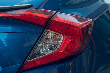 Macro view of modern blue car xenon lamp taillight, bumper, rear trunk lid. Exterior of a modern carの写真素材
