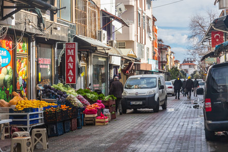 side; Turkey â€“ February 01 2022: city street with a fruit and vegetable store, a parked car...