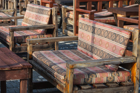 close-up of a wooden bench with cushions on the seats in beautiful oriental patternsの写真素材