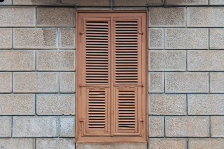 Close-up brown wooden vintage window in an old stone houseの写真素材