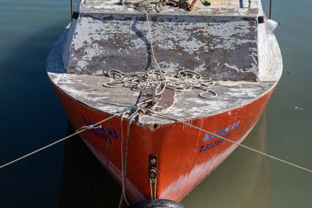 Side, Turkey â February 02 2022: Wooden side of the red boat with a ropes against the background of sea waterの写真素材