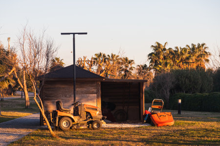 side; Turkey â February 01 2022: A small warehouse, a professional lawn mower stands on a lawn on a tourist embankmentのeditorial素材