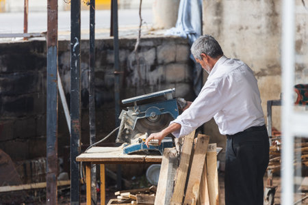 Side, Turkey â February 06 2022: carpenter work with circular saw for cutting boards, the man sawed bars, construction and home renovation, repair and construction toolのeditorial素材
