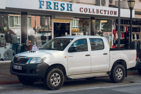 Side, Turkey â€“ February 16 2022: white Toyota Hilux parked on the street on a warm summer day...
