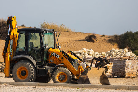 Side, Turkey â€“ February 18 2022: tractor-excavator for the demolition of an old building....