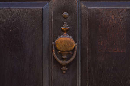 old-fashioned metal handle.Doorknocker on allwood door.の写真素材